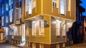 A multi-story building with a prominent corner entrance, large windows, and a balcony. - Home Quality Hotel (Istanbul)