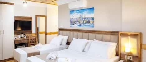 A hotel room with a large bed, bedside tables, a wooden ceiling, and a painting on the wall.