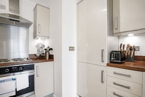 A kitchen with stainless steel appliances, wooden countertops, and modern cabinetry. - Stylish Flat • City Centre • Balcony • FreeParking (Milton Keynes)