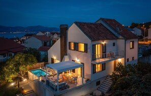 A two-story house with a swimming pool, outdoor seating, and a balcony. - Stunning home in Supetar with private swimming pool, can be inside or outside (Supetar)
