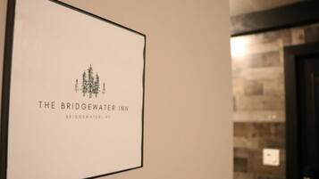 A framed sign for The Bridgwater Inn with a simple logo of trees and the inn's name.