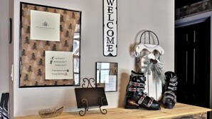 A reception desk with a framed welcome sign, a menu board, and a pair of roller skates.