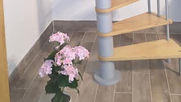 A spiral staircase with wooden steps and metal railings.