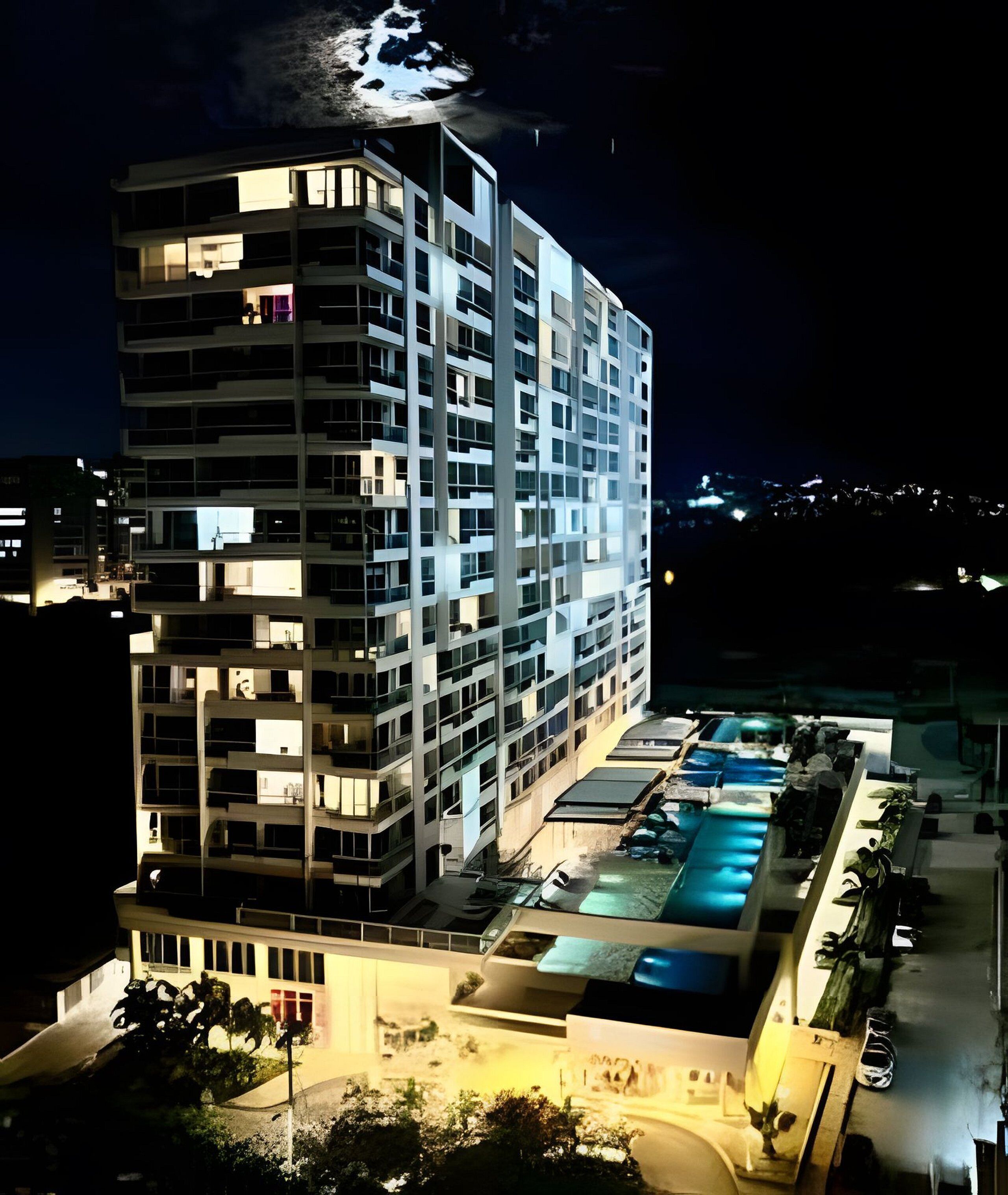 A multi-story hotel with a pool area.