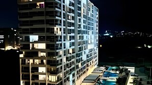 A multi-story hotel with a pool area.