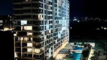 A multi-story hotel with a pool area.