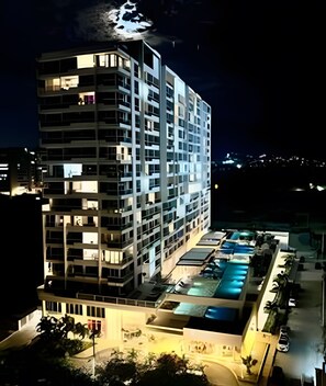 A multi-story hotel with a pool area.