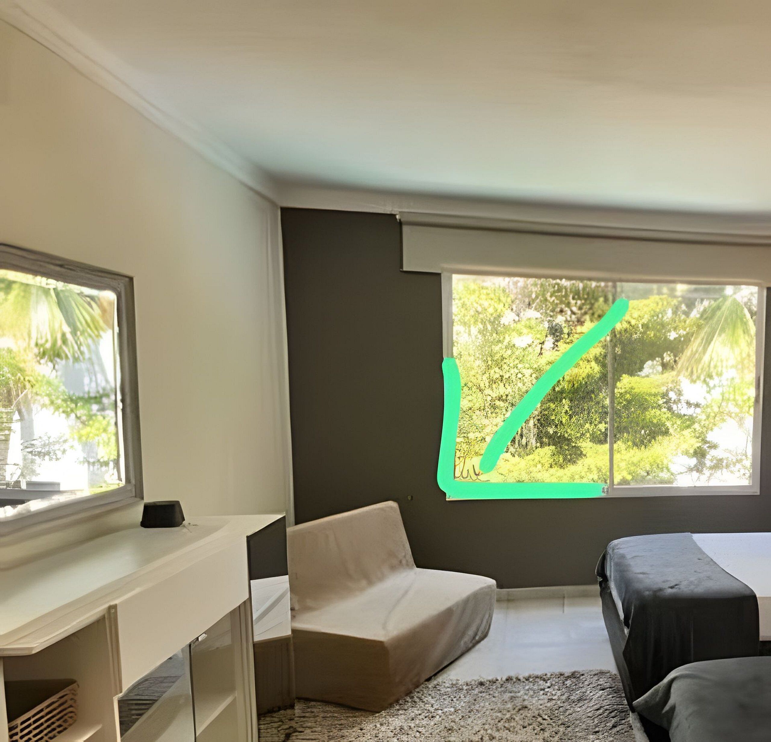 A room with a bed, a desk, and two windows.