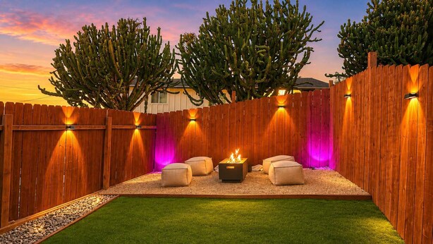 A backyard with a wooden fence, a fire pit, and outdoor seating. - Private Patio & Fire Pit Near San Diego (Spring Valley)
