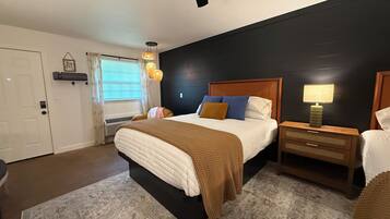 A bedroom with a bed, bedside tables, a lamp, and a ceiling fan.