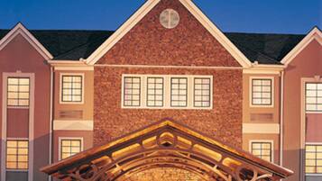 A large brick building with a prominent entrance and multiple windows.