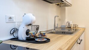 A modern kitchen with a coffee machine, a kettle, and a sink. - The Lane, Arona Center, AC, Wi-Fi by Guestaly (Arona)
