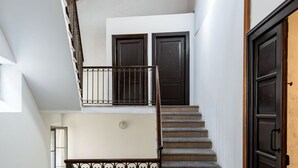 A staircase with a handrail and a door at the bottom. - The Lane, Arona Center, AC, Wi-Fi by Guestaly (Arona)