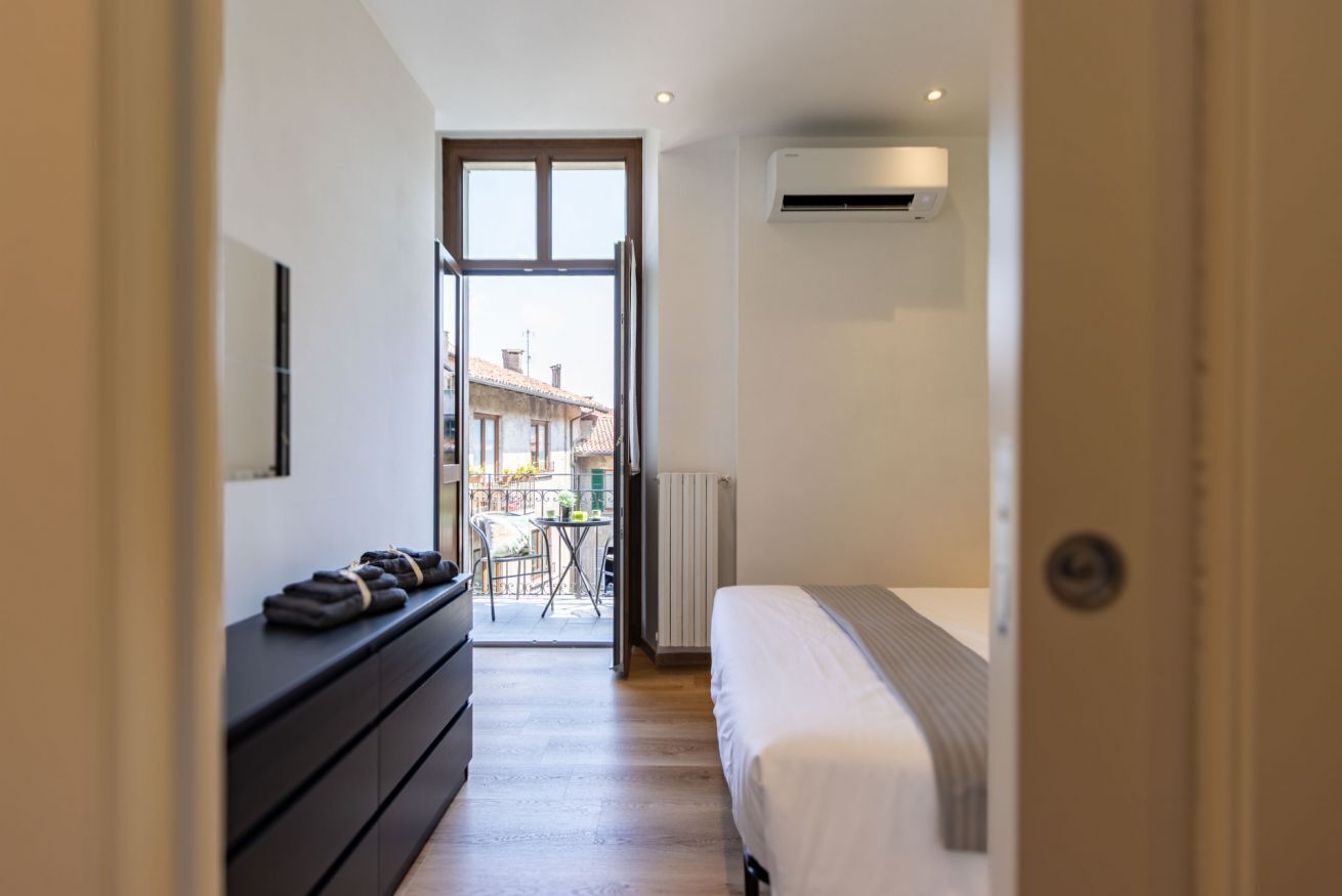 Ein Hotelzimmer mit Bett, einem Schrank und Blick ins Freie.