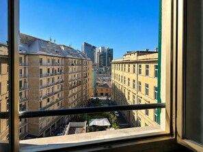 A view from a window overlooking a cityscape with multi-story buildings, including a prominent skyscraper. - Heart of Genoa, 5 min from Brignole (Genova)