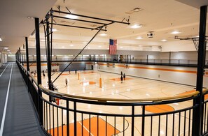 An indoor basketball court with a high ceiling, a basketball hoop, and an American flag. - NEW Dolly Fireworks View! 3 King, LuxHotTub, Fence Yd (Pigeon Forge)