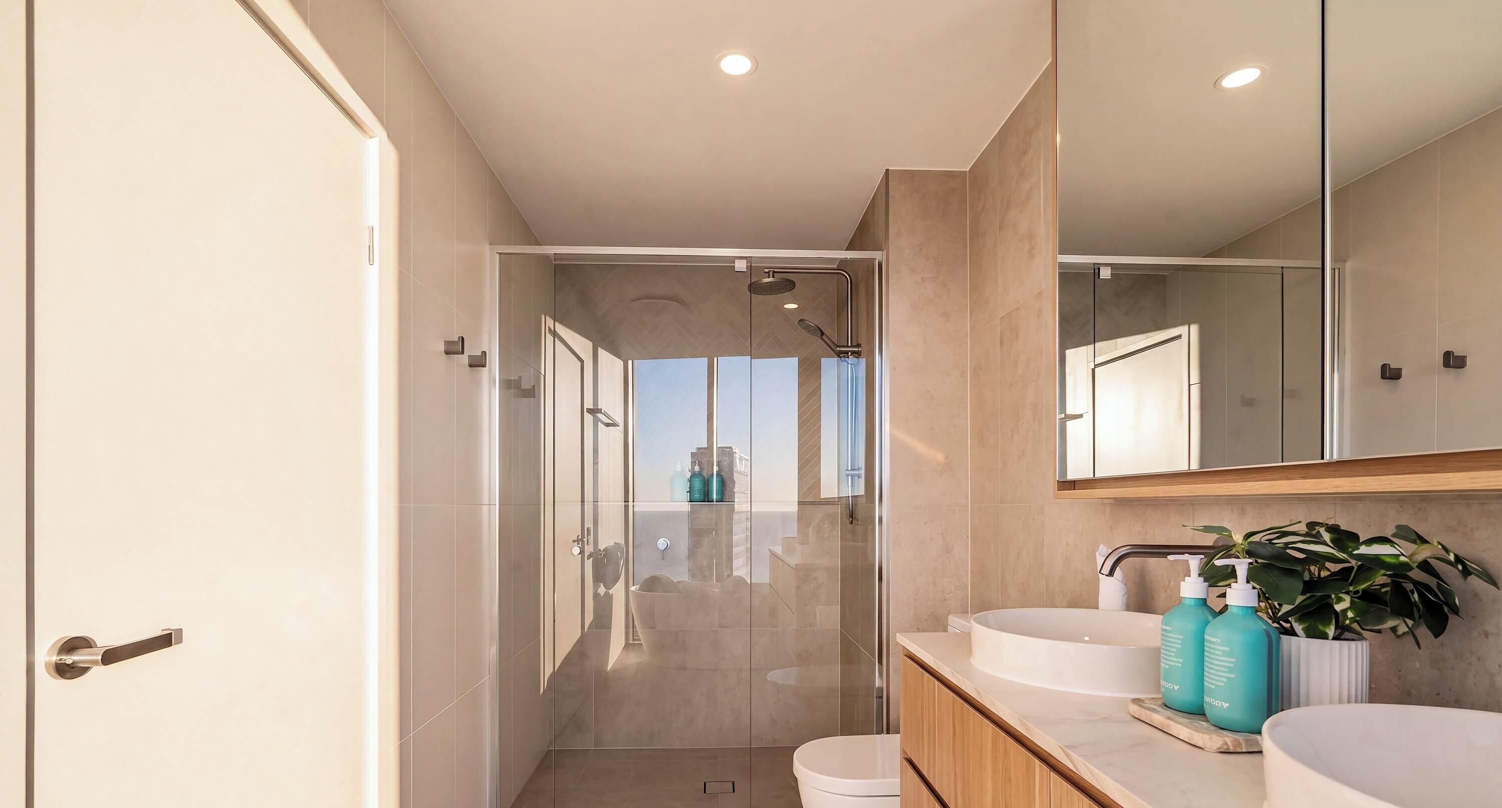 A modern bathroom with a shower, toilet, and sink area.