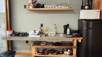 Full-size fridge, microwave, stovetop, cookware/dishes/utensils