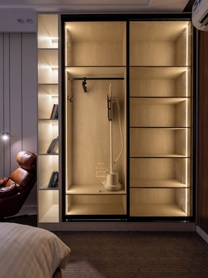 A modern room with a large wardrobe, a leather chair, and a carpeted floor.