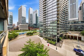 A modern urban area with high-rise buildings, a central roundabout, and a tram line. - DT Gem near the CN Tower & Rogers Centre! (Toronto)