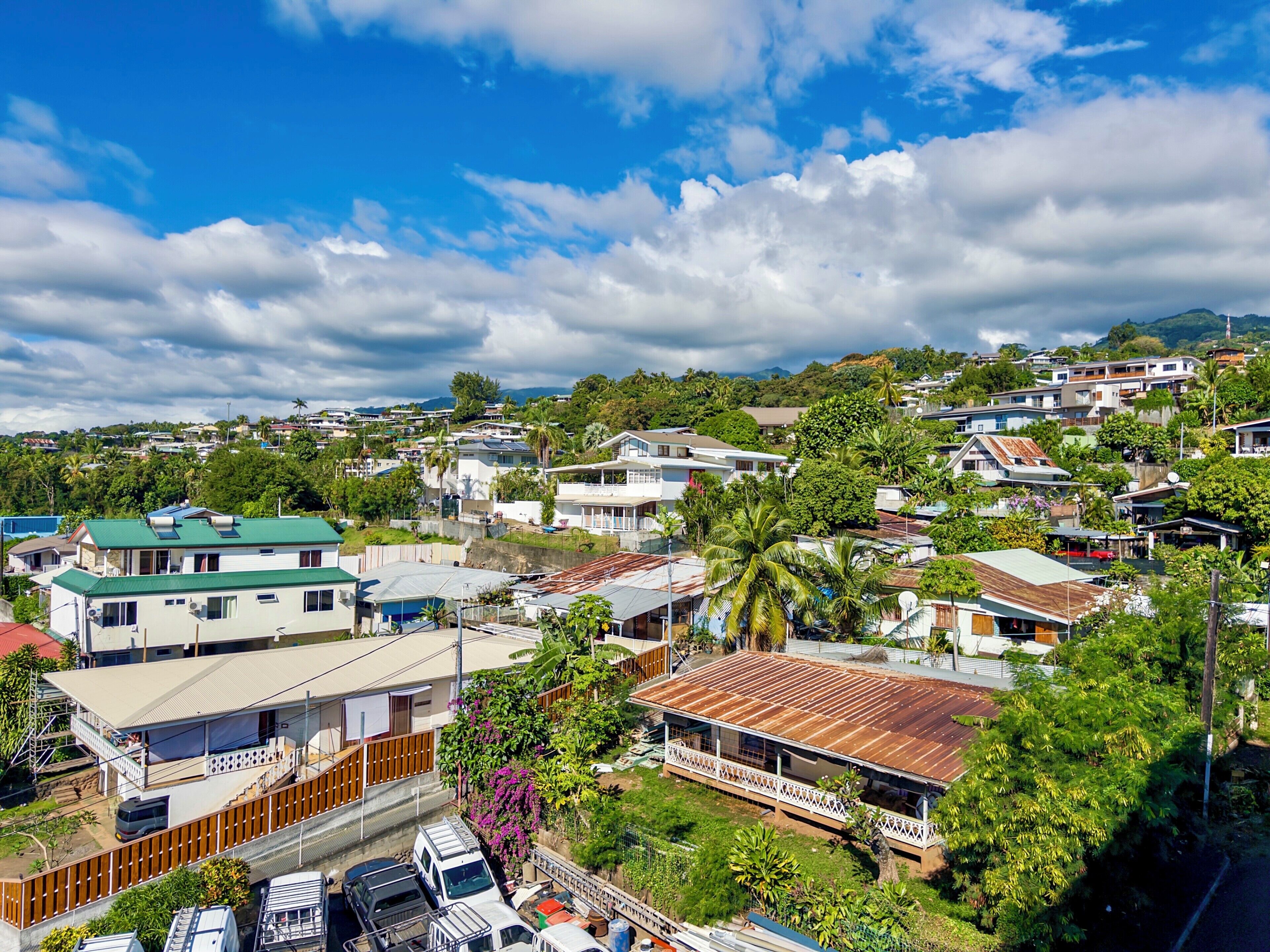 A residential area with houses, a street, and a clear sky.