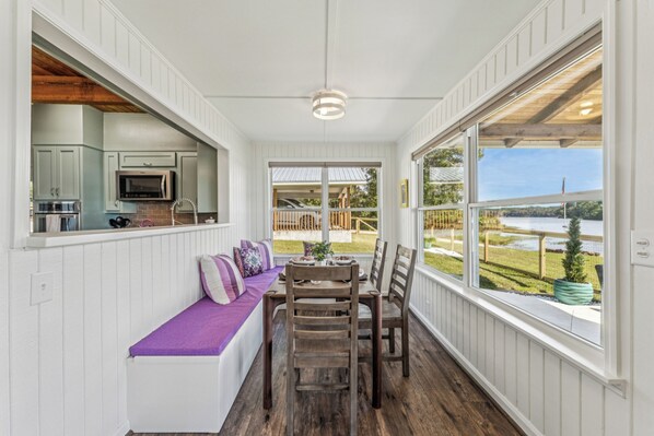 A kitchen with white cabinets and a built-in microwave.