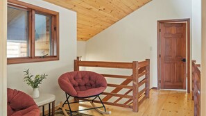 A room with a wooden ceiling, a wooden door, and a window with a view of a wooden structure outside. - Winter Court by Avantstay Game Room Private Basketball Court Fire Pit Near Skiing & Raceway (Pocono Summit)