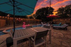 A backyard with a pool, outdoor furniture, and a hammock. - Home Theater - Game Room - Pool - Hot Tub - Golf (Plano)