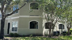 A two-story building with a symmetrical facade, arched windows, and a central entrance. - Cozy Avalon 1-bedroom in beautiful Clearwater-newly remodeled (Clearwater)