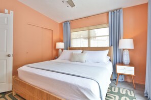 A bedroom with a bed, two bedside tables, a window with curtains, and a door. - Designer Sarasota Retreat - Heated Pool - Minutes to Siesta Key (Sarasota)