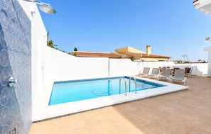 A rooftop swimming pool with a clear blue sky, surrounded by lounge chairs and a white wall with a decorative pattern. - Awesome home in Nerja with private swimming pool, can be inside or outside (Nerja)