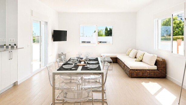 A modern kitchen with a dining area, a sofa, and a TV mounted on the wall. - Awesome home in Nerja with private swimming pool, can be inside or outside (Nerja)