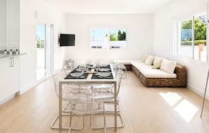 A modern kitchen with a dining area, a sofa, and a TV mounted on the wall. - Awesome home in Nerja with private swimming pool, can be inside or outside (Nerja)