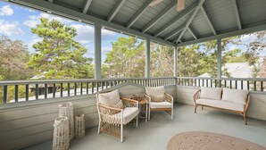 A covered outdoor seating area with wicker furniture and a ceiling fan. - Magnolia Cottages on 30A: 5-Min Walk to the Beach! 2 King Beds, Bunk Room (Inlet Beach)
