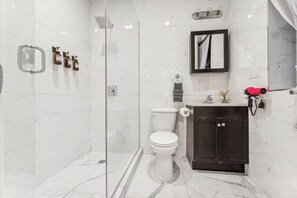 Een douche, een haardroger, een bidet, handdoeken