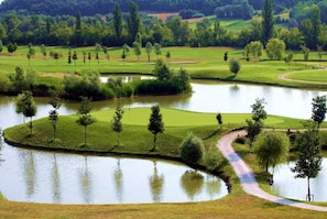A golf course with multiple ponds, pathways, and trees. - Villa Lampina - private villa on luxury estate (Varignana-Palesio)