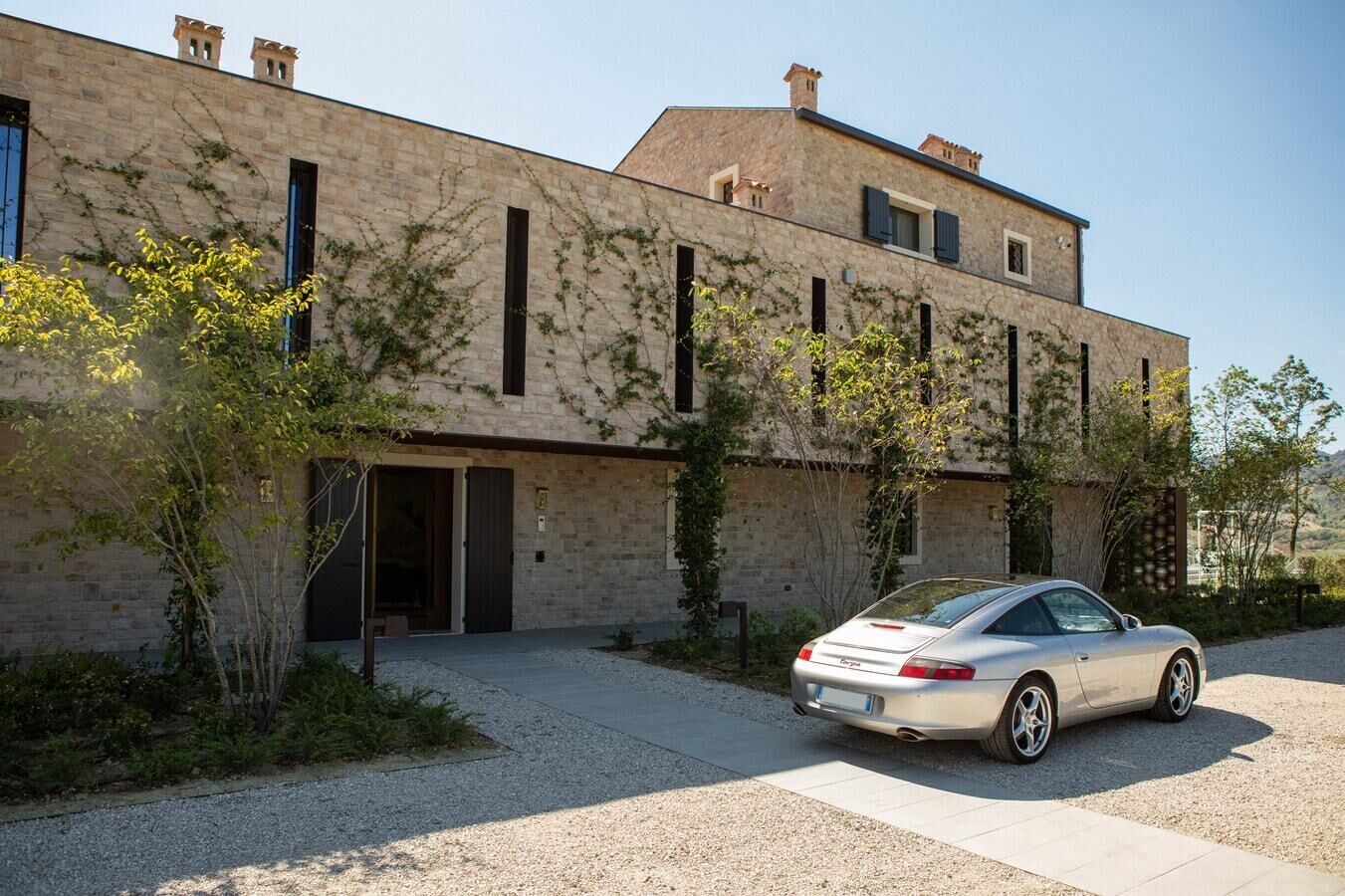 A modern building with a car parked in front.
