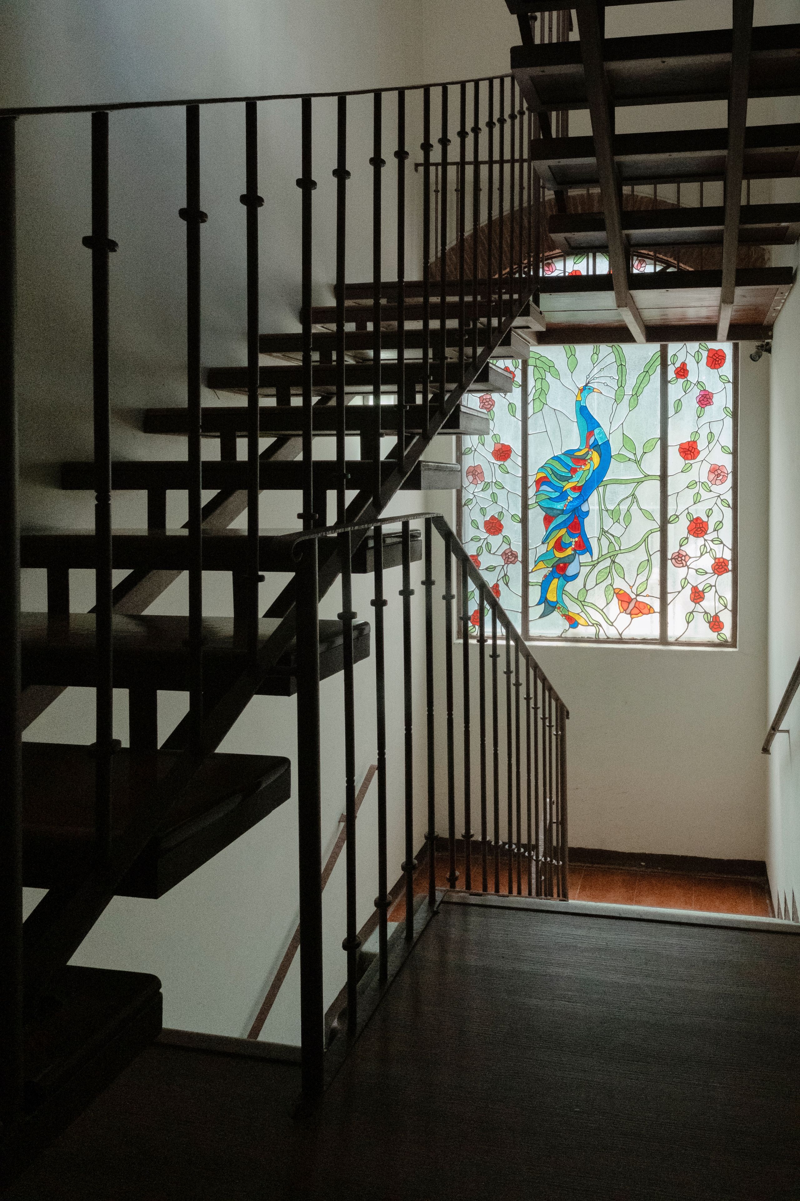 A staircase with a metal railing leading to a landing.