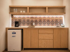 A compact kitchenette with a coffee maker, a mini-fridge, and a sink. - Don Manuel - Luxury Apartments & Studios (Oaxaca)