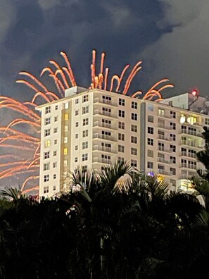 A multi-story building with a flat roof and balconies, surrounded by dense foliage. - “No pasa nada” (Pompano Beach)