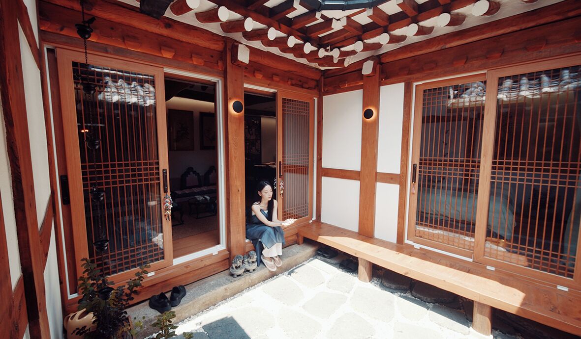 A traditional Japanese-style entrance with wooden doors and a stone-paved area.
