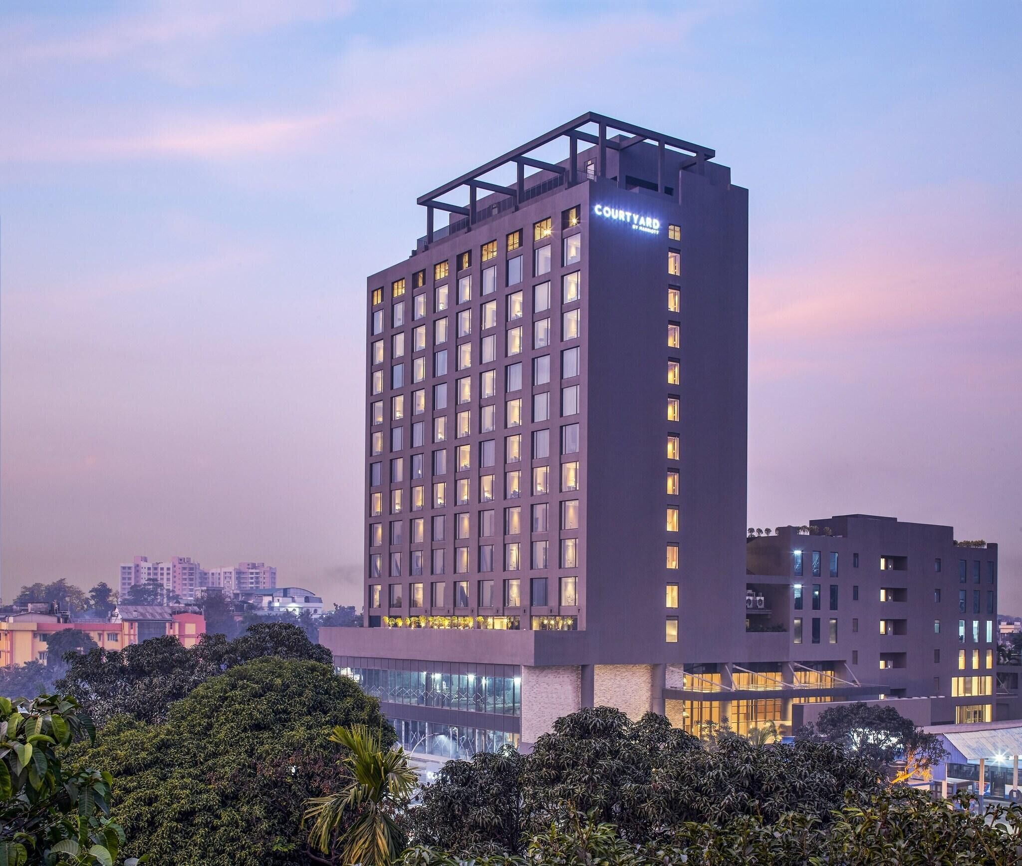 A high-rise hotel with multiple floors, large windows, and a prominent sign.