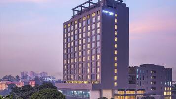 A high-rise hotel with multiple floors, large windows, and a prominent sign.