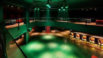 A multi-level auditorium with tiered seating and a stage.