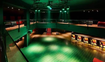 A multi-level auditorium with tiered seating and a stage.