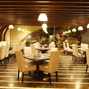 Ein Restaurant mit modernem Interieur, mit Tischen und Stühlen für die Gastronomie eingerichtet.