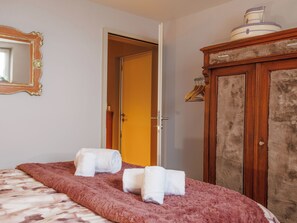 A room with a bed, a wardrobe, a mirror, and a door. - Lau'tentik by Interhome (Collombey-Muraz)
