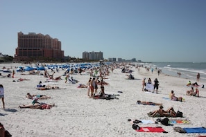 A crowded beach with numerous umbrellas and people sunbathing. - Coastal Relaxation! Amazing Views! Pool, Beach Gear and FREE Parking! ~ 510 Gulf Shores (Indian Shores)