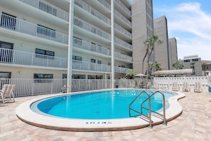 A swimming pool with a no diving sign, surrounded by lounge chairs and a high-rise building in the background. - Coastal Relaxation! Amazing Views! Pool, Beach Gear and FREE Parking! ~ 510 Gulf Shores (Indian Shores)