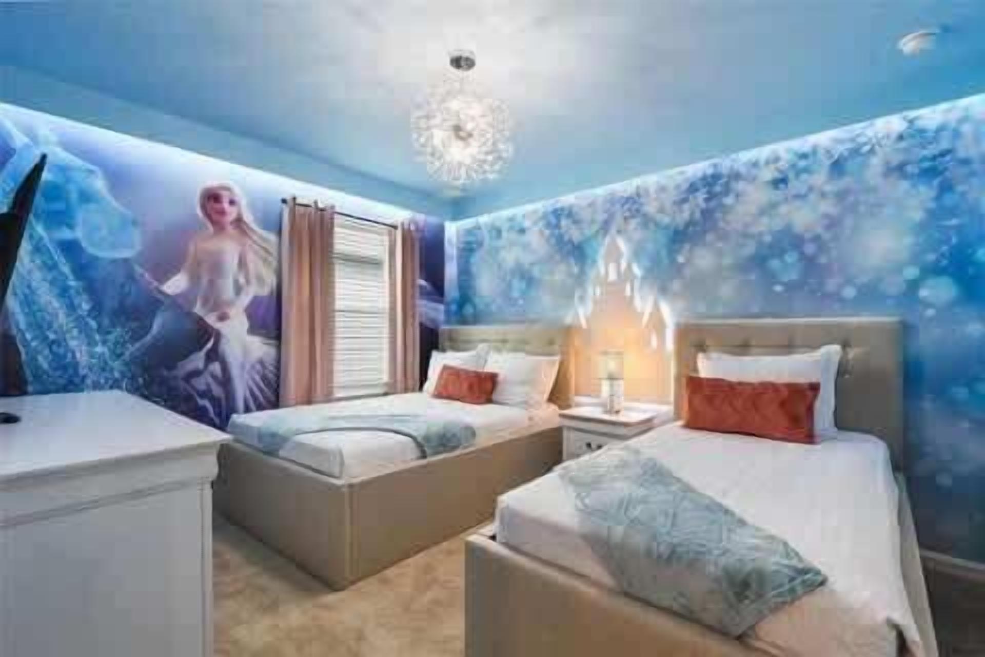 A bedroom with two beds, a nightstand, and a wall mural.